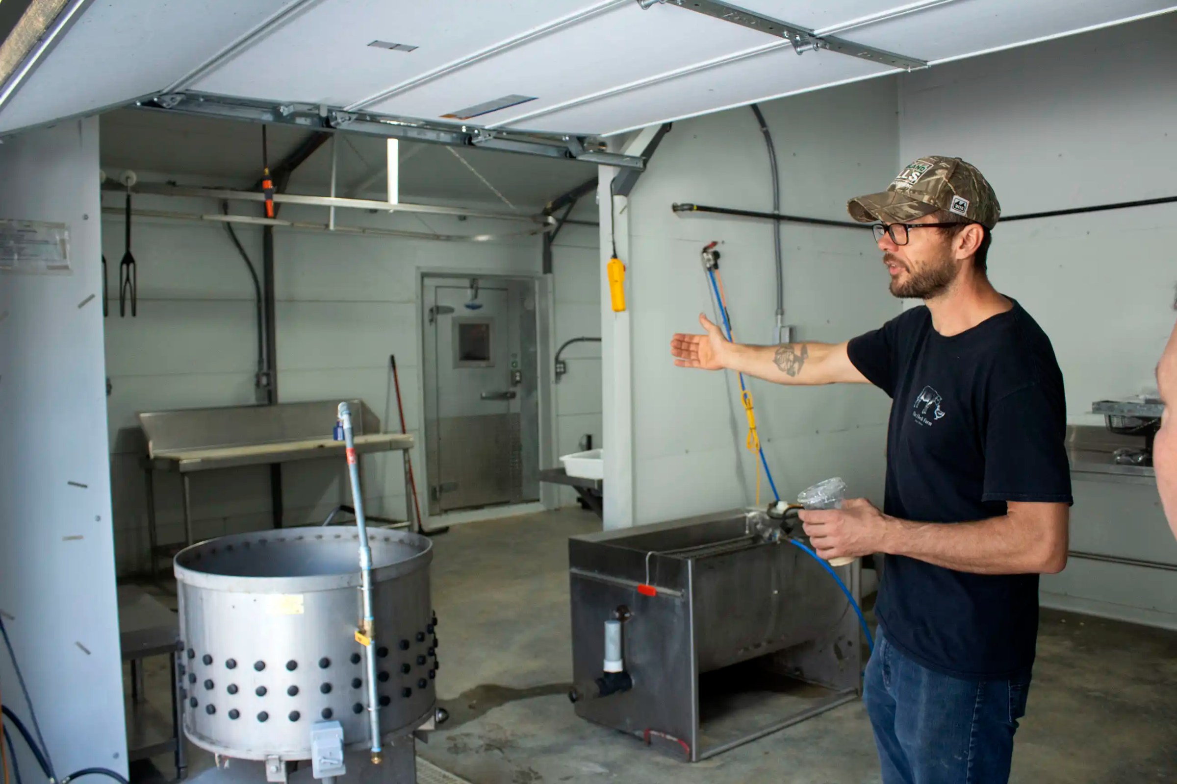 a photo of Flock Farm owner Brent Glays showing off his on-farm chicken processing facility